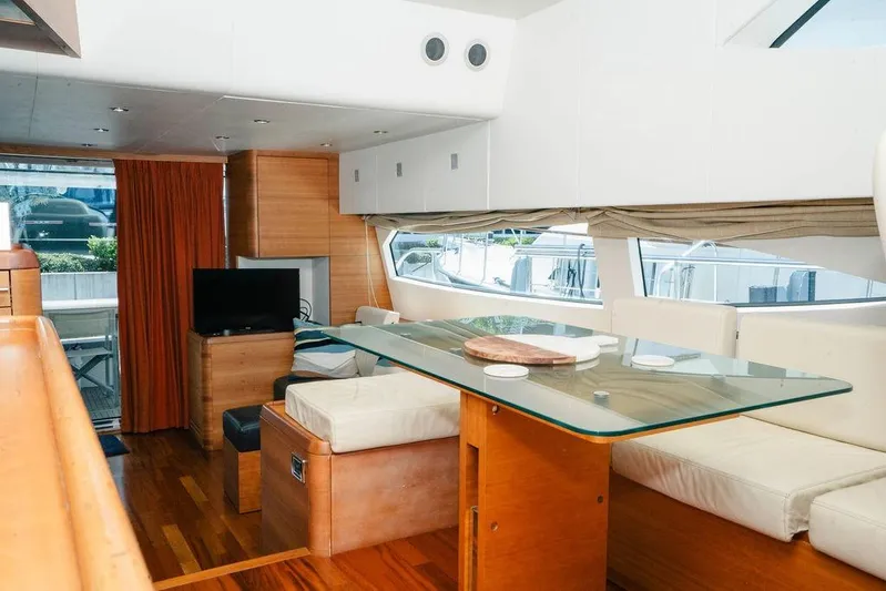 Voluptas Yacht Photos Pics Luxurious 2006 Aicon Flybridge yacht interior with modern dining area and elegant furnishings.