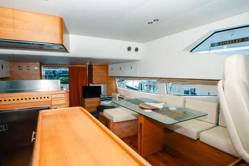 Voluptas Yacht Photos Pics Luxurious 2006 Aicon Flybridge yacht interior with modern dining area and wooden finishes.