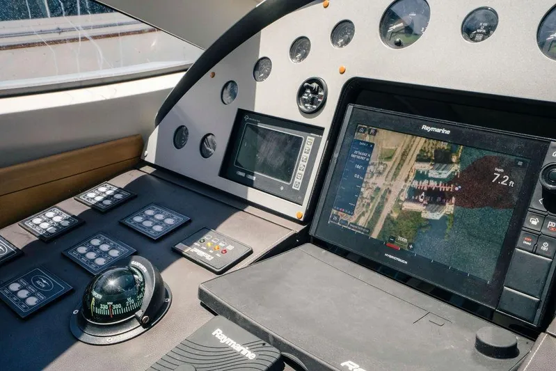 Voluptas Yacht Photos Pics Control panel of 2006 Aicon Flybridge yacht with navigation screens and compass.