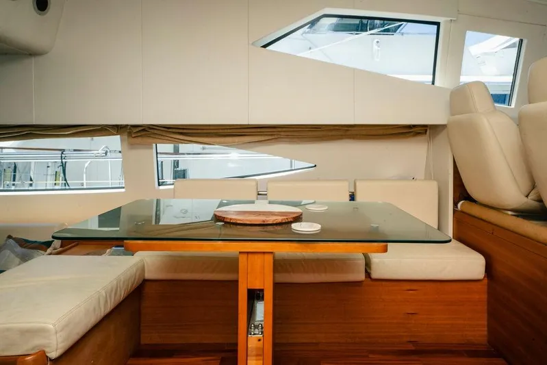 Voluptas Yacht Photos Pics Interior of 2006 Aicon Flybridge yacht with elegant seating and glass table.
