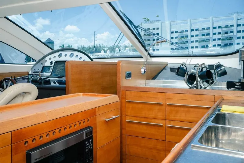 Voluptas Yacht Photos Pics Luxurious 2006 Aicon Flybridge yacht interior with modern kitchen and navigation controls.