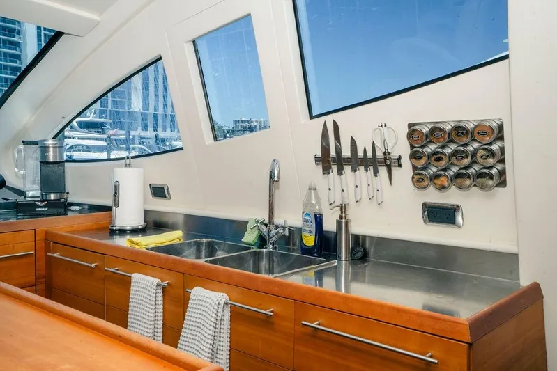 Voluptas Yacht Photos Pics Modern kitchen interior on 2006 Aicon Flybridge yacht with stainless steel sink and knife rack.