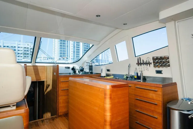 Voluptas Yacht Photos Pics Interior of 2006 Aicon Flybridge yacht with modern kitchen and large windows.