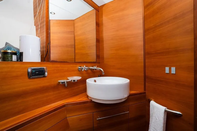 Voluptas Yacht Photos Pics Luxurious wooden bathroom interior on 2006 Aicon Flybridge yacht, featuring modern sink and fixtures.