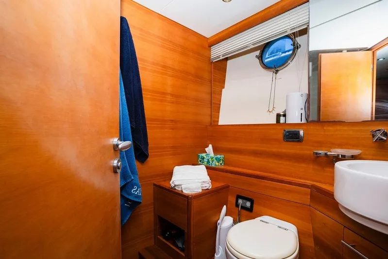 Voluptas Yacht Photos Pics Luxurious 2006 Aicon Flybridge yacht bathroom with wooden interior and modern amenities.