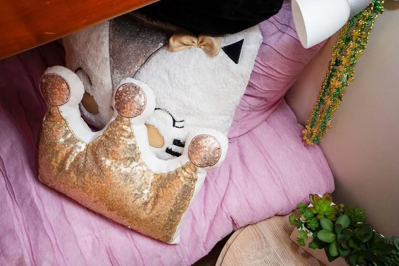 Voluptas Yacht Photos Pics Plush crown pillow on pink bedding inside 2006 Aicon Flybridge yacht cabin.