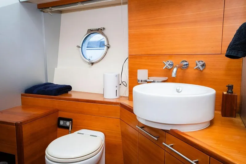 Voluptas Yacht Photos Pics Luxurious 2006 Aicon Flybridge yacht bathroom with modern fixtures and wooden cabinetry.