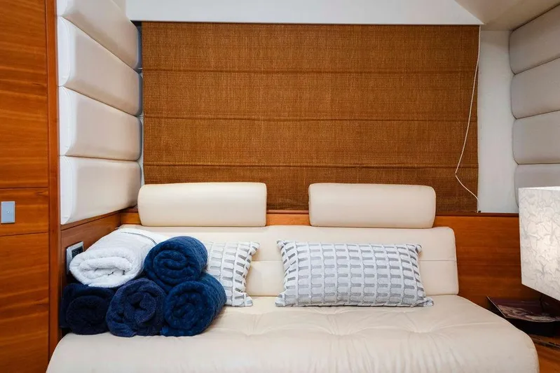 Voluptas Yacht Photos Pics Luxurious interior of 2006 Aicon Flybridge yacht with plush seating and rolled towels.