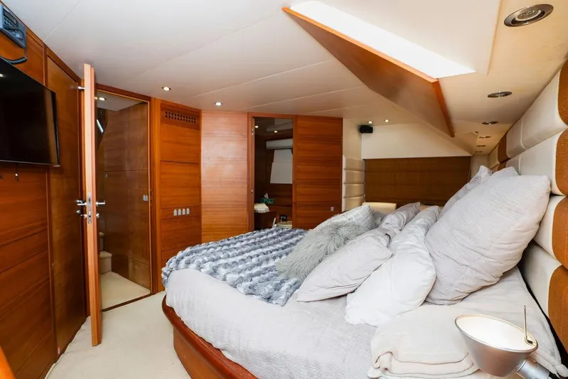 Voluptas Yacht Photos Pics Luxurious bedroom interior of 2006 Aicon Flybridge yacht with wood paneling and plush bedding.