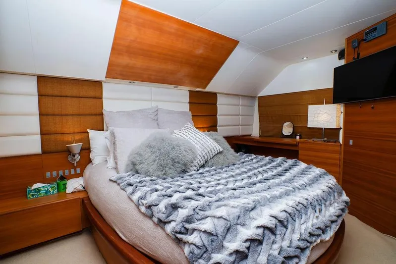 Voluptas Yacht Photos Pics Luxurious bedroom interior on 2006 Aicon Flybridge yacht with plush bedding and modern decor.