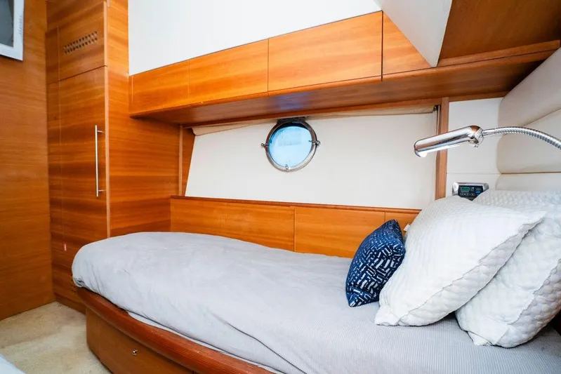 Voluptas Yacht Photos Pics Luxurious 2006 Aicon Flybridge yacht cabin with wooden interior and cozy bedding.