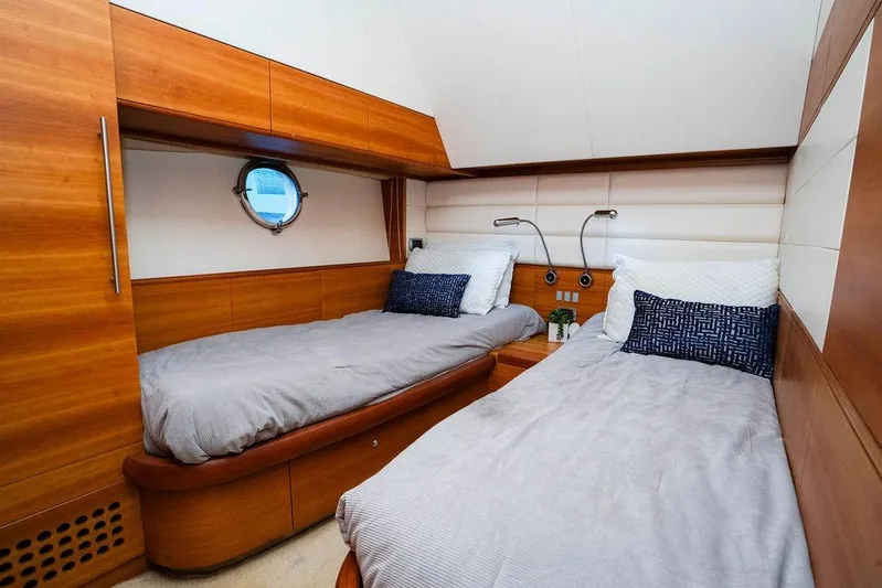 Voluptas Yacht Photos Pics Luxurious twin cabin interior of 2006 Aicon Flybridge yacht with wooden finishes.