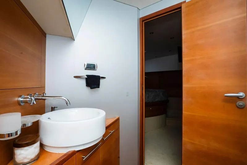 Voluptas Yacht Photos Pics Luxurious bathroom interior on a 2006 Aicon Flybridge yacht, featuring modern fixtures and wooden accents.