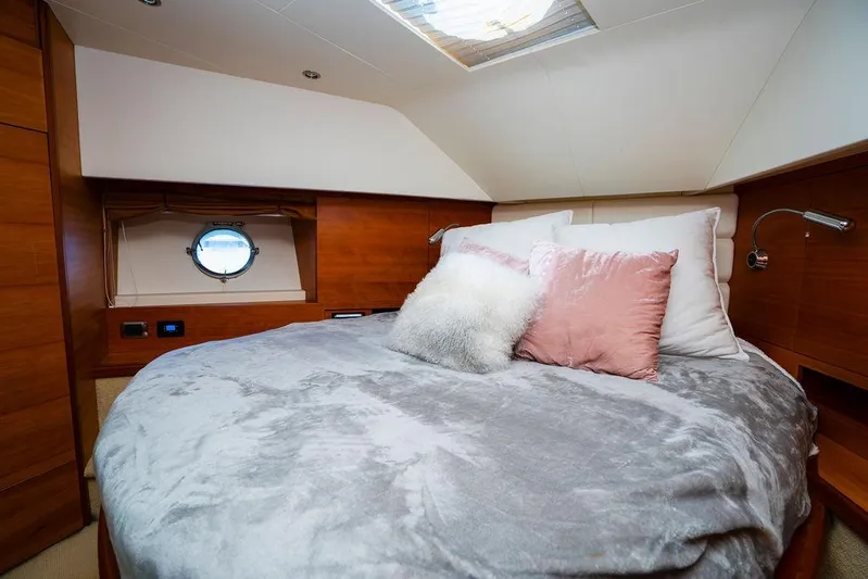 Voluptas Yacht Photos Pics Luxurious bedroom interior of 2006 Aicon Flybridge yacht with plush bedding and wooden accents.