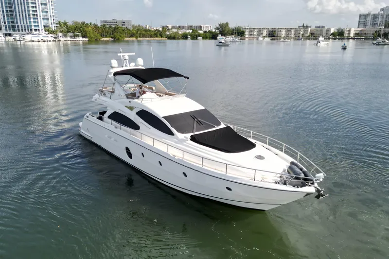 Voluptas Yacht Photos Pics 2006 Aicon Flybridge yacht cruising in a serene marina setting.