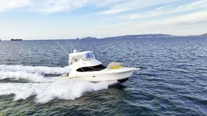  Yacht Photos Pics 2012 Riviera Convertible yacht cruising on open sea under clear sky.