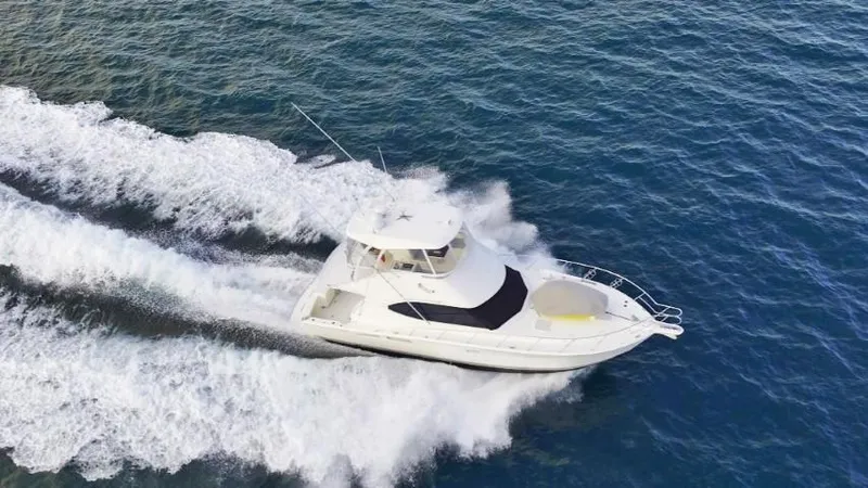  Yacht Photos Pics 2012 Riviera Convertible yacht cruising on open sea, aerial view.