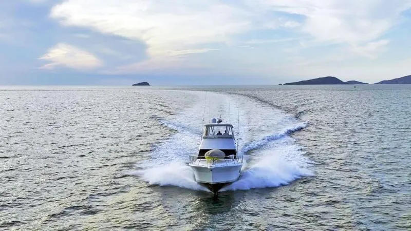  Yacht Photos Pics Riviera Convertible 2012 boat cruising on open water with scenic island backdrop.