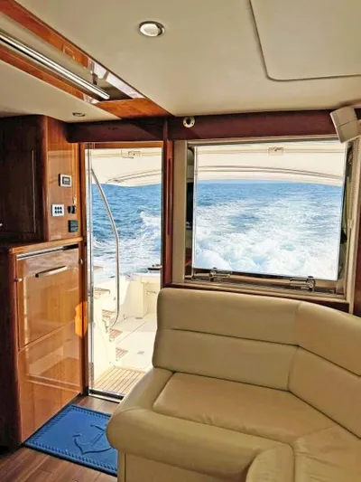  Yacht Photos Pics Interior of 2012 Riviera Convertible yacht with ocean view through open door.