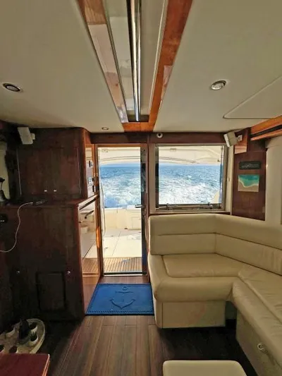  Yacht Photos Pics Interior of 2012 Riviera Convertible yacht with ocean view through open door.