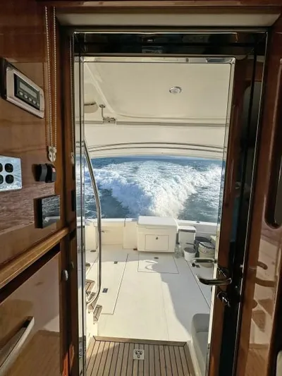  Yacht Photos Pics Interior view of 2012 Riviera Convertible yacht with ocean waves in the background.
