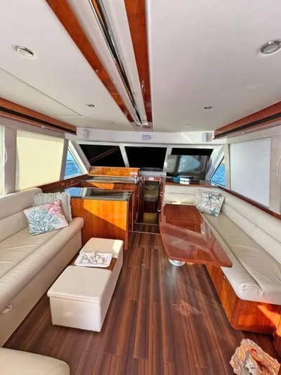  Yacht Photos Pics Luxurious 2012 Riviera Convertible yacht interior with elegant wood finishes and plush seating.
