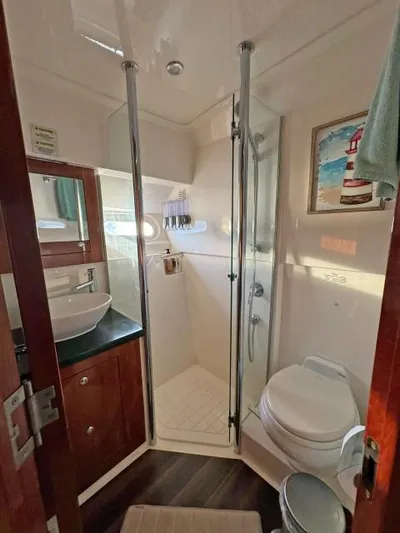  Yacht Photos Pics 2012 Riviera Convertible yacht bathroom with shower, sink, and toilet.
