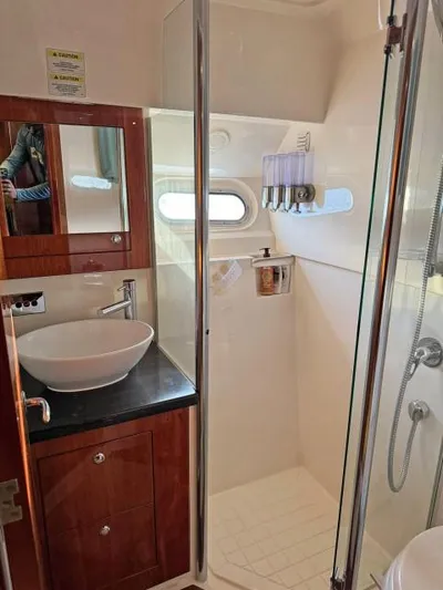  Yacht Photos Pics Luxurious 2012 Riviera Convertible yacht bathroom with modern fixtures and glass shower.
