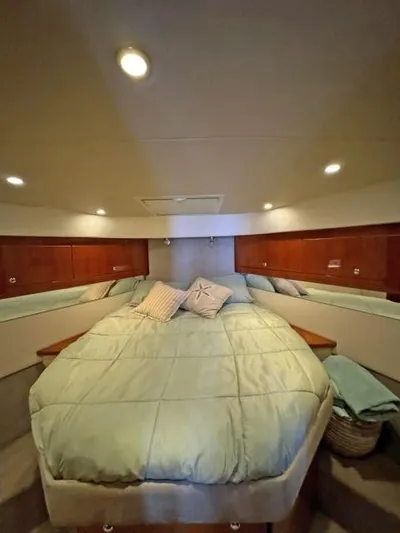  Yacht Photos Pics Luxurious 2012 Riviera Convertible cabin with cozy bedding and ambient lighting.