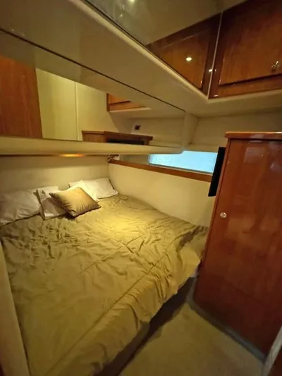  Yacht Photos Pics Luxurious 2012 Riviera Convertible cabin with cozy bed and wooden cabinetry.