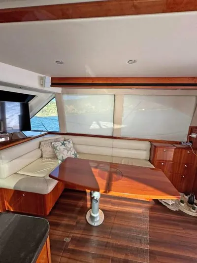  Yacht Photos Pics 2012 Riviera Convertible yacht interior with wood accents and cozy seating area.
