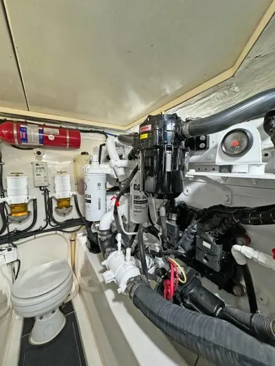  Yacht Photos Pics Engine room of 2012 Riviera Convertible with visible filters and fire extinguisher.