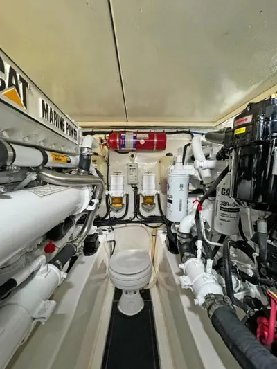  Yacht Photos Pics Engine room of 2012 Riviera Convertible with CAT Marine Power components and fire extinguisher.