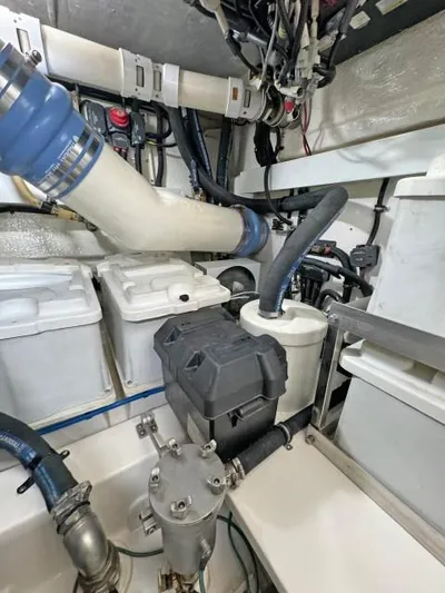  Yacht Photos Pics Engine room of 2012 Riviera Convertible boat with visible pipes and machinery.