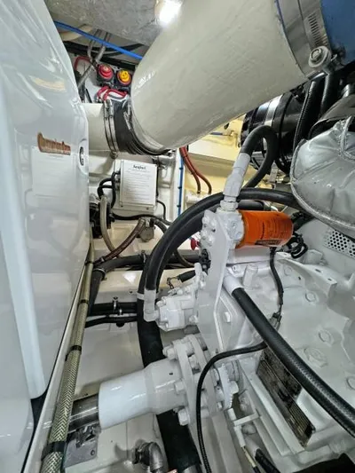  Yacht Photos Pics Engine room of a 2012 Riviera Convertible boat, showcasing mechanical components and piping.