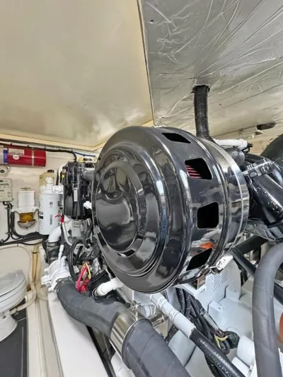  Yacht Photos Pics Engine room of a 2012 Riviera Convertible boat, showcasing mechanical components and wiring.