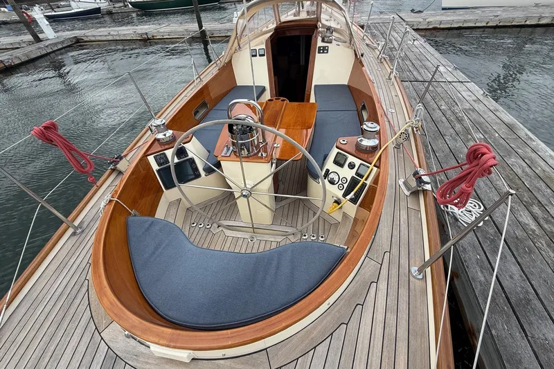Sea Suite Yacht Photos Pics Hinckley DS 42 sailboat cockpit, 2015 model, docked with wooden deck and steering wheel.