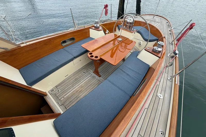 Sea Suite Yacht Photos Pics Hinckley DS 42 sailboat cockpit, 2015 model, featuring wooden accents and blue cushioned seating.