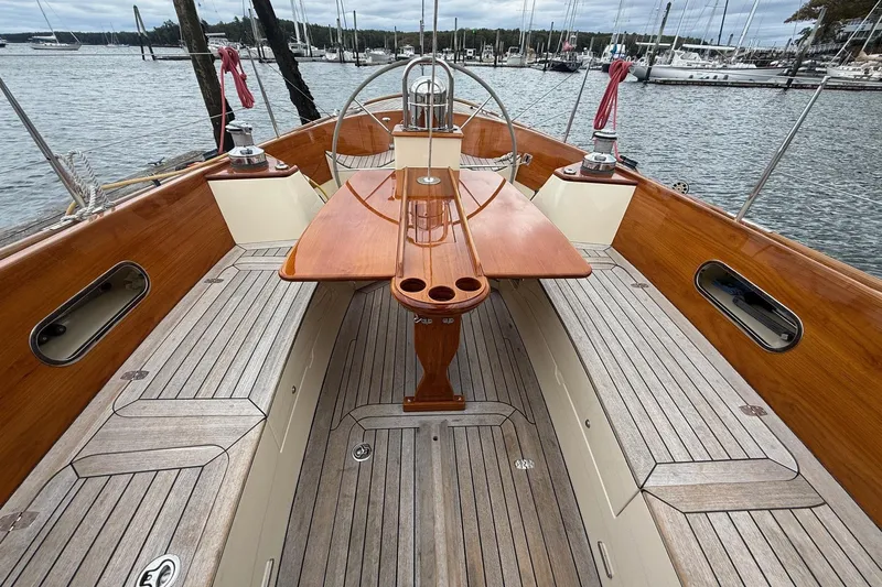 Sea Suite Yacht Photos Pics Hinckley DS 42 sailboat cockpit, 2015 model, featuring wooden accents and marina backdrop.