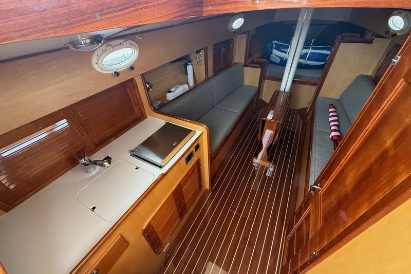 Sea Suite Yacht Photos Pics Interior of 2015 Hinckley DS 42 sailboat with wooden finishes and compact seating area.