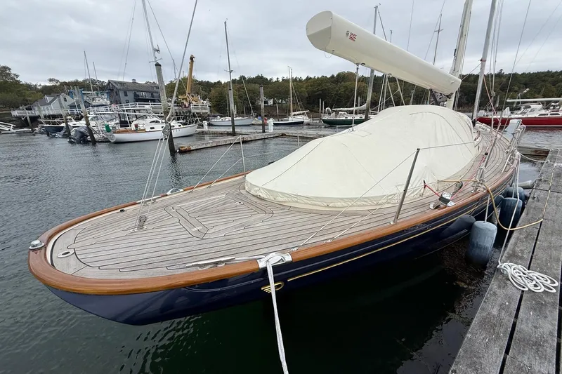 Sea Suite Yacht Photos Pics 2015 Hinckley DS 42 sailboat docked at a marina, featuring a sleek wooden deck.