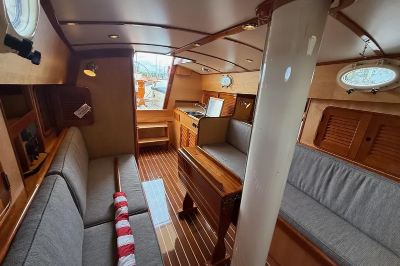 Sea Suite Yacht Photos Pics Interior of 2015 Hinckley DS 42 sailboat with wooden finishes and cozy seating.