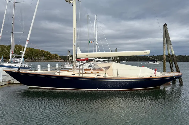 Sea Suite Yacht Photos Pics 2015 Hinckley DS 42 sailboat docked in a marina under cloudy skies.