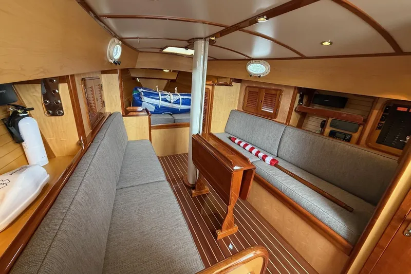 Sea Suite Yacht Photos Pics Interior of 2015 Hinckley DS 42 sailboat with wooden finishes and seating area.
