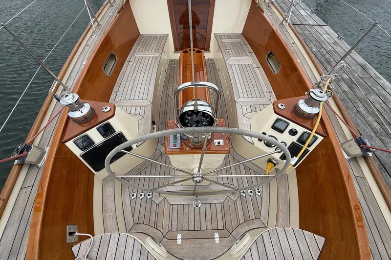 Sea Suite Yacht Photos Pics Hinckley DS 42 sailboat cockpit, 2015 model, featuring wooden accents and steering wheel.