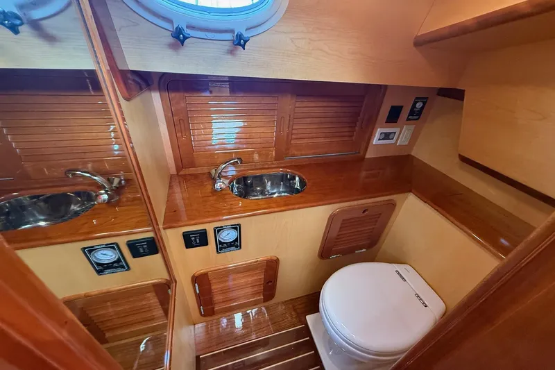 Sea Suite Yacht Photos Pics Luxurious wooden bathroom interior of 2015 Hinckley DS 42 yacht with sink and toilet.