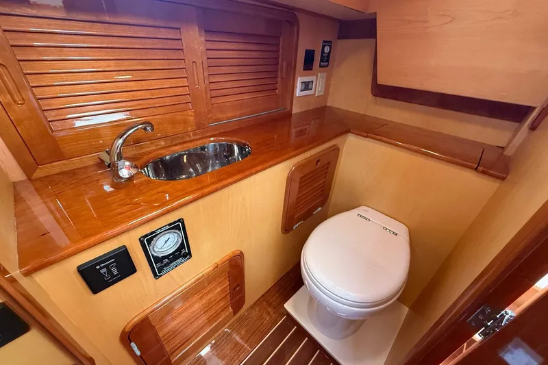 Sea Suite Yacht Photos Pics Luxurious 2015 Hinckley DS 42 yacht bathroom with wooden cabinetry and modern fixtures.