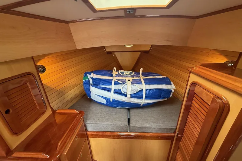 Sea Suite Yacht Photos Pics Hinckley DS 42 cabin interior, 2015 model, featuring wooden paneling and a neatly stored sail.