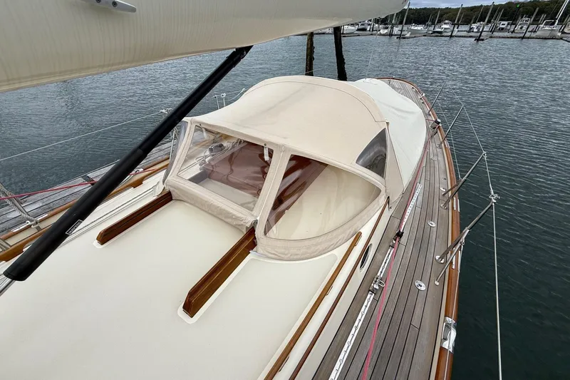 Sea Suite Yacht Photos Pics Hinckley DS 42 sailboat, 2015 model, docked with beige canopy and wooden deck.