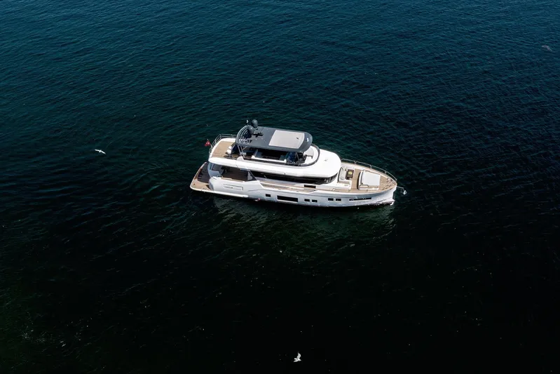  Yacht Photos Pics Aerial view of 2024 Sirena 68 yacht cruising on open water.